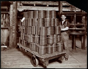 Interior view of a man working with leather at the New York Leather Belting Co., New York, 1906 by Byron Company